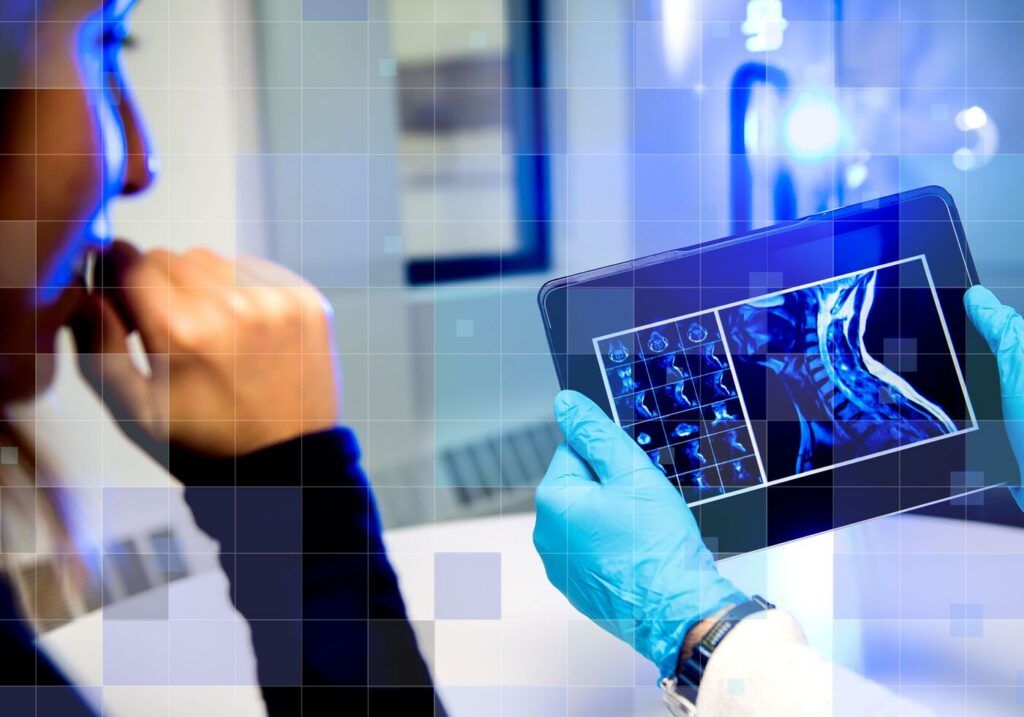 A photo illustration with light graphic overlays on a photo of two people reading a medical scan on an iPad