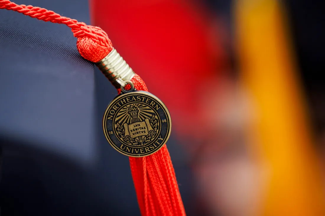 Decorative photo of a tassel with a Northeastern pin