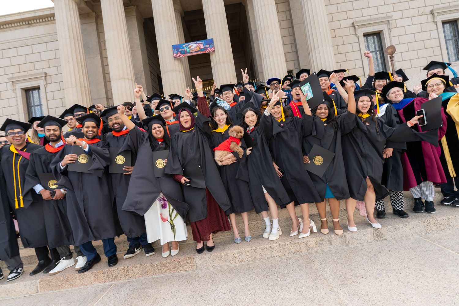 The class cheers in front of the venue after the commencement ceremony of May 8 2026