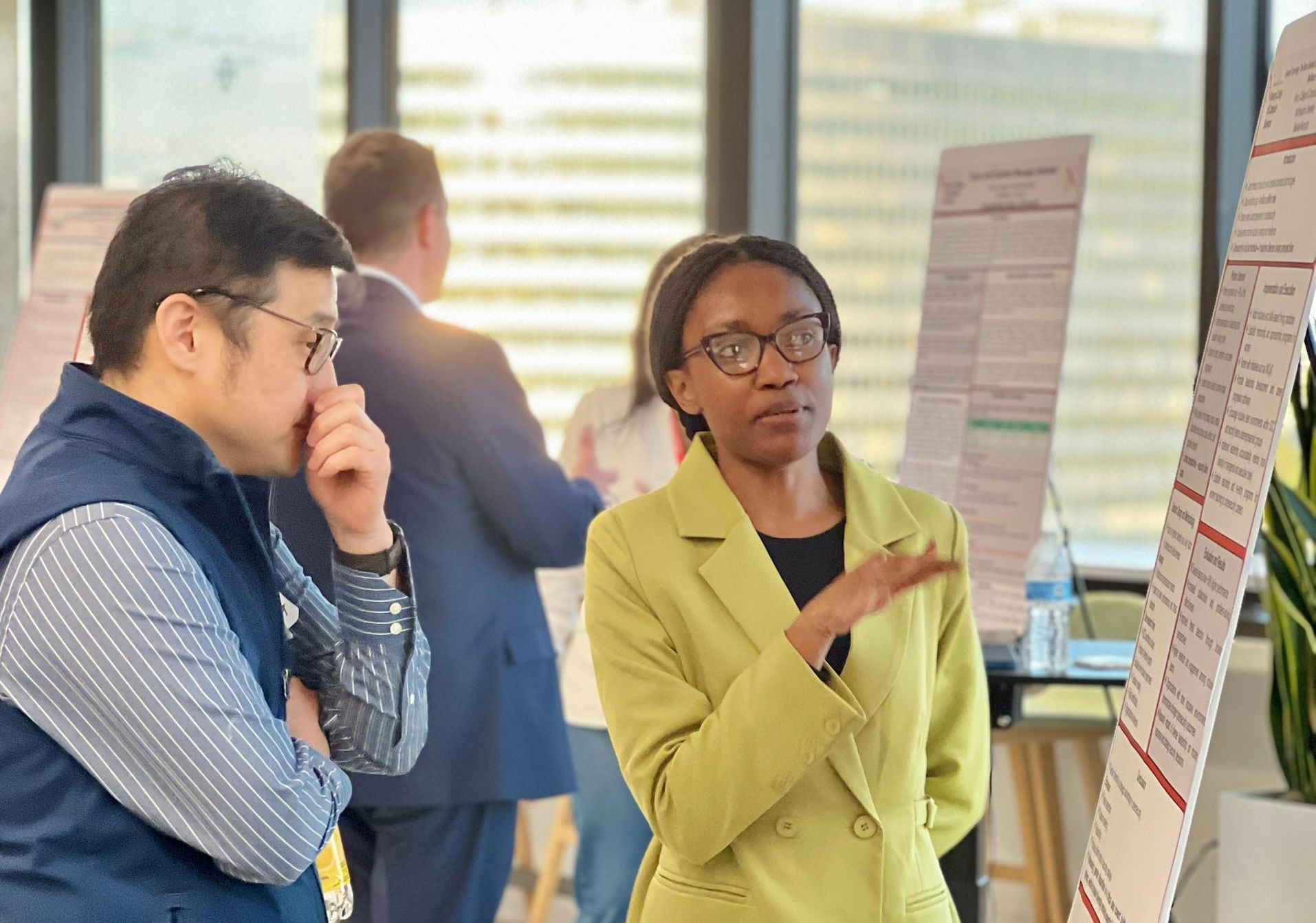 Makaito Murogodo speaks with a visitor during the research showcase in spring 2026